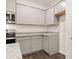 A modern kitchen features gray cabinets, granite countertops, stainless steel appliances, and hardwood floors at 452 Reflection Dr # 19, Stockbridge, GA 30281
