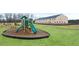 Community playground with new equipment surrounded by mulch and with green grass at 452 Reflection Dr # 19, Stockbridge, GA 30281
