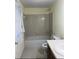 A traditional bathroom featuring a shower-tub combo and a vanity at 7123 Williamsburg Dr, Riverdale, GA 30274