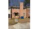 A two-story red brick house with a walkway leading up to a front door at 7123 Williamsburg Dr, Riverdale, GA 30274
