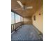 Overhead shot of a screened-in porch with wooden flooring, railing, and a ceiling fan at 7123 Williamsburg Dr, Riverdale, GA 30274