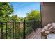 Relaxing balcony with seating, views of trees, and a black metal railing at 1903 Anjaco Rd # 5, Atlanta, GA 30309
