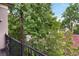 Green views from the balcony of an apartment complex with black metal railing and wood floors at 1903 Anjaco Rd # 5, Atlanta, GA 30309