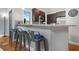 Kitchen counter with grey metal bar stools, dark brown cabinets, and stainless steel appliances at 1903 Anjaco Rd # 5, Atlanta, GA 30309