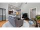 Contemporary living room with hardwood floors, a cozy sofa, and an adjacent kitchen at 1903 Anjaco Rd # 5, Atlanta, GA 30309