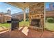 Cozy back patio with a stone fireplace and grill, perfect for outdoor entertaining at 416 Culloden Moor Dr, Mcdonough, GA 30253