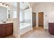 Bathroom featuring a large soaking tub, a separate shower, and dual vanities, providing a spa-like experience at 416 Culloden Moor Dr, Mcdonough, GA 30253