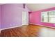 Bright pink bedroom with hardwood floors and natural light from the window, perfect for adding a personal touch at 416 Culloden Moor Dr, Mcdonough, GA 30253