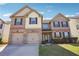 Two-story brick and siding home featuring a two-car garage and manicured front lawn at 416 Culloden Moor Dr, Mcdonough, GA 30253