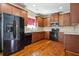 Modern kitchen with dark wood cabinets, granite countertops, and hardwood flooring at 416 Culloden Moor Dr, Mcdonough, GA 30253