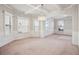 Bright living space with coffered ceiling, large windows, and a chandelier focal point at 416 Culloden Moor Dr, Mcdonough, GA 30253