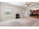 Open-concept living room with fireplace, leading to a kitchen with dark wood cabinetry at 416 Culloden Moor Dr, Mcdonough, GA 30253