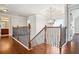 A beautifully crafted staircase features wooden banisters and a stylish chandelier, adding elegance to the home's interior at 416 Culloden Moor Dr, Mcdonough, GA 30253