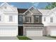 Charming townhome showcasing a stone facade and a two-car garage for added curb appeal at 206 Bastian Dr # 107, Villa Rica, GA 30180