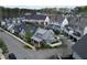 An aerial view showing craftsman homes in a cozy neighborhood with mature trees and sidewalks at 240 Mado Ln, Chattahoochee Hills, GA 30268