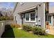 Cozy backyard featuring a small lawn, trimmed hedges, and access to the main house, perfect for outdoor enjoyment at 240 Mado Ln, Chattahoochee Hills, GA 30268