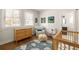 Bedroom featuring warm wood finishes and a playful cloud-patterned rug at 240 Mado Ln, Chattahoochee Hills, GA 30268