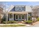 Charming home featuring a metal roof and inviting front porch with brick accents at 240 Mado Ln, Chattahoochee Hills, GA 30268
