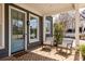 Cozy front porch with brick flooring and comfortable rocking chairs, perfect for relaxing at 240 Mado Ln, Chattahoochee Hills, GA 30268