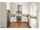 Modern kitchen boasts stainless steel appliances, white cabinets, and elegant countertops at 240 Mado Ln, Chattahoochee Hills, GA 30268