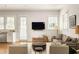 Comfortable living area showcasing natural light and stylish decor with easy access to kitchen at 240 Mado Ln, Chattahoochee Hills, GA 30268