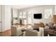 Bright and airy living room open to a modern kitchen, creating a welcoming space at 240 Mado Ln, Chattahoochee Hills, GA 30268