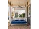 Relax on this covered porch swing, complete with a ceiling fan, for outdoor enjoyment at 240 Mado Ln, Chattahoochee Hills, GA 30268