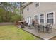 Backyard patio features an outdoor dining area, brick fireplace and green grass at 3000 Storybook Ln, Grayson, GA 30017