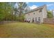 Large backyard boasts a patio with outdoor dining area, green grass, and a privacy fence at 3000 Storybook Ln, Grayson, GA 30017
