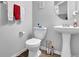 Cozy half-bathroom with pedestal sink, decorative mirror, and grey walls at 3000 Storybook Ln, Grayson, GA 30017