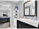 Bathroom features a white marble countertop, black vanity, and decorative mirror at 3000 Storybook Ln, Grayson, GA 30017