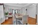 Bright dining area with hardwood floors, modern table with seating for six, open to the living room at 3000 Storybook Ln, Grayson, GA 30017