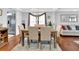 Bright dining area with hardwood floors, neutral paint, modern table with six chairs, and ample natural light at 3000 Storybook Ln, Grayson, GA 30017