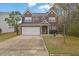 Charming two-story brick home featuring a well-manicured lawn and two-car garage with nice curb appeal at 3000 Storybook Ln, Grayson, GA 30017
