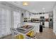 Eat-in kitchen with white cabinets, stainless steel appliances, modern lighting, and access to the exterior at 3000 Storybook Ln, Grayson, GA 30017