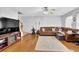 Spacious living room featuring hardwood floors, neutral paint, a plush sofa, and ceiling fan at 3000 Storybook Ln, Grayson, GA 30017