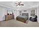 Spacious main bedroom featuring a tray ceiling, ceiling fan, and dresser at 3000 Storybook Ln, Grayson, GA 30017