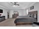 Spacious main bedroom featuring a tray ceiling, ceiling fan, and dresser at 3000 Storybook Ln, Grayson, GA 30017