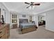 Spacious main bedroom featuring a tray ceiling, ceiling fan, and a dresser at 3000 Storybook Ln, Grayson, GA 30017