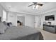Spacious main bedroom featuring a tray ceiling, ceiling fan, and TV with console at 3000 Storybook Ln, Grayson, GA 30017