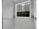 Glass-enclosed shower with marble surround, window, and modern fixtures at 3000 Storybook Ln, Grayson, GA 30017