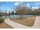 Community tennis court surrounded by a fence and landscaping at 3000 Storybook Ln, Grayson, GA 30017