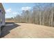 Large backyard with grass, trees, and a wooden privacy fence at 345 Orwell Dr, Social Circle, GA 30025