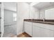 Bright bathroom with double vanity, granite countertop, and hardwood flooring at 345 Orwell Dr, Social Circle, GA 30025