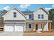 Charming two-story home with a painted brick facade and a two-car garage at 345 Orwell Dr, Social Circle, GA 30025