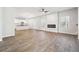 Open concept living room with fireplace, windows, and light-colored wood floors at 345 Orwell Dr, Social Circle, GA 30025
