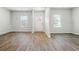 Open concept living room with light colored walls and wood floors at 345 Orwell Dr, Social Circle, GA 30025