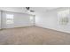 Spacious main bedroom with neutral carpeting, ceiling fan and large windows for natural light at 345 Orwell Dr, Social Circle, GA 30025