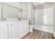Bathroom with white vanity, matching cabinetry, and a tub with shower combo with a tile surround at 4319 Alysheba Dr, Fairburn, GA 30213