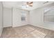 Bright bedroom featuring neutral walls, carpet floors, a ceiling fan, and natural light from two windows at 4319 Alysheba Dr, Fairburn, GA 30213